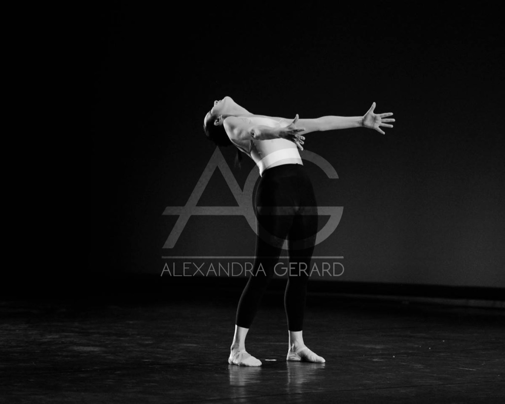 Alexandra Gérard dancing solo on stage, arched with arms open, black-and-white photograph